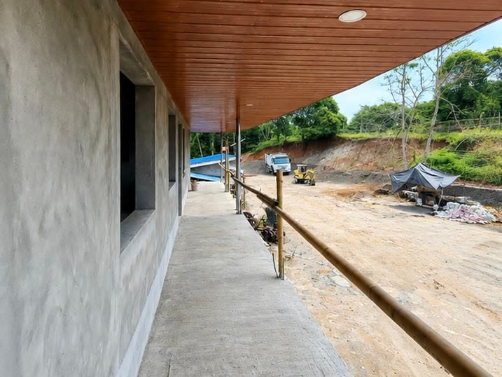 The rendered walkway with its timber lined soffit running the length of the elevation