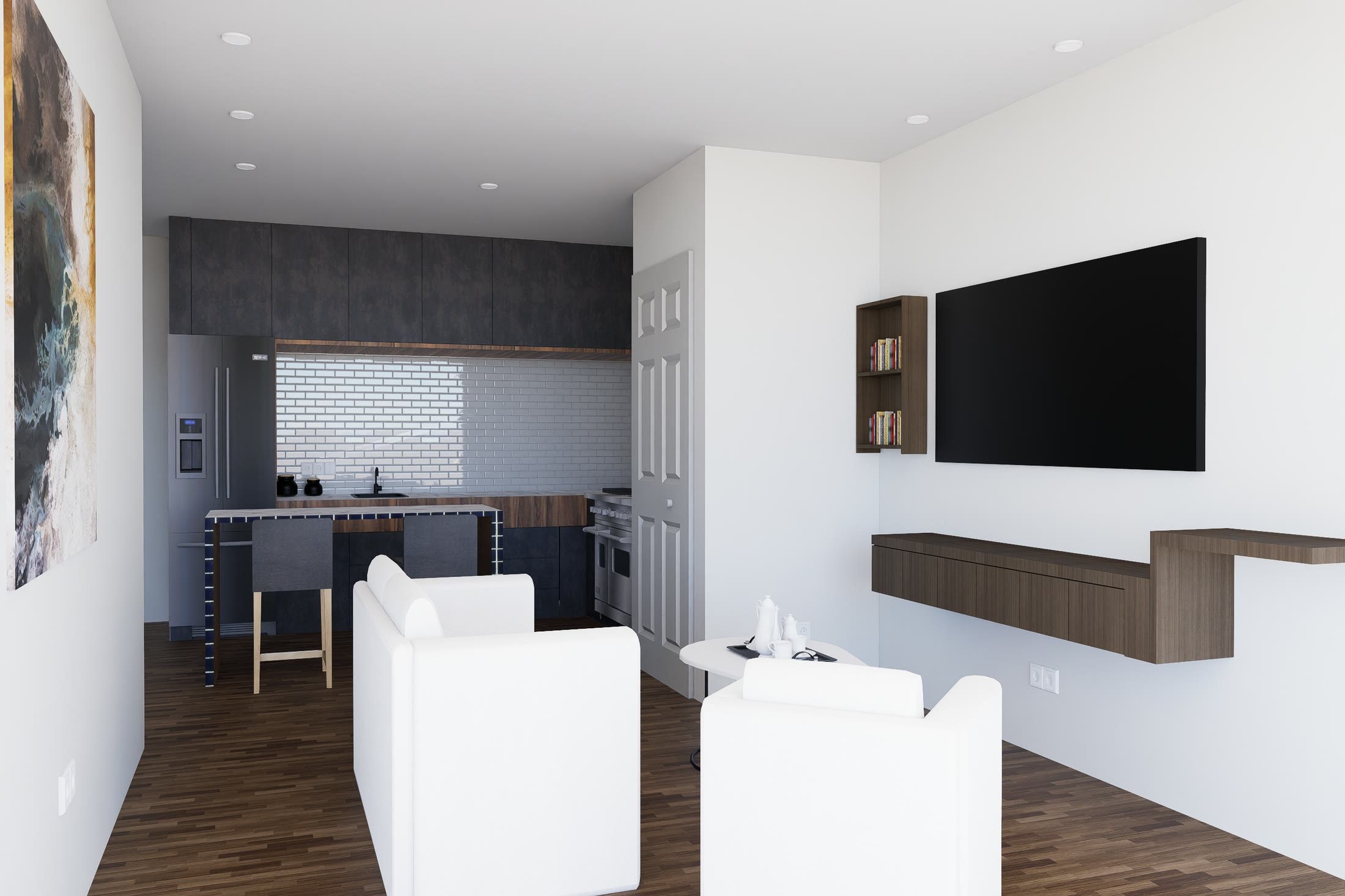 Living room of a one-bedroom unit with the kitchen behind it, a wall mounted television and a timber floor