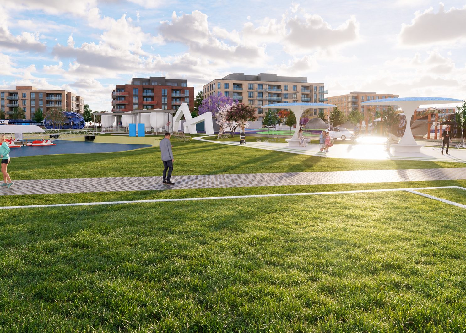 The playing field at sunset, the white canopy structures and the district buildings along the far edge